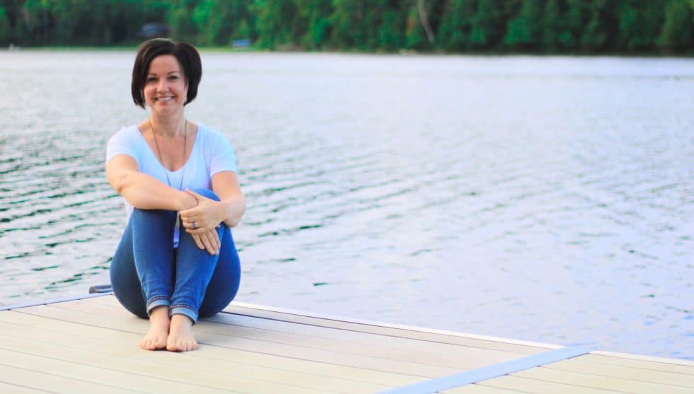 Andrea Parker sitting on dock