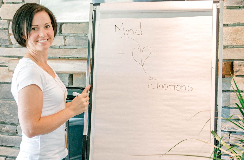 Smiling at camera, writing on bulletin board