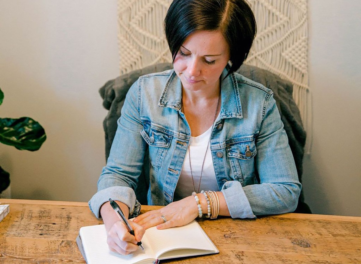 Andrea parker writing at desk