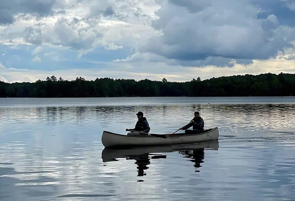 Andrea Parker and Wife in canoe on lake