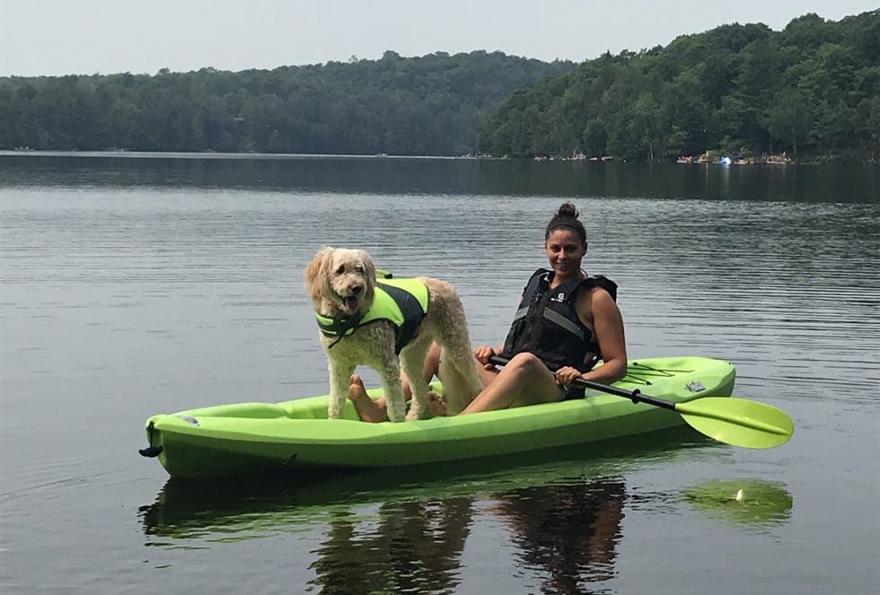 Mel Mills on Kayak with Dog